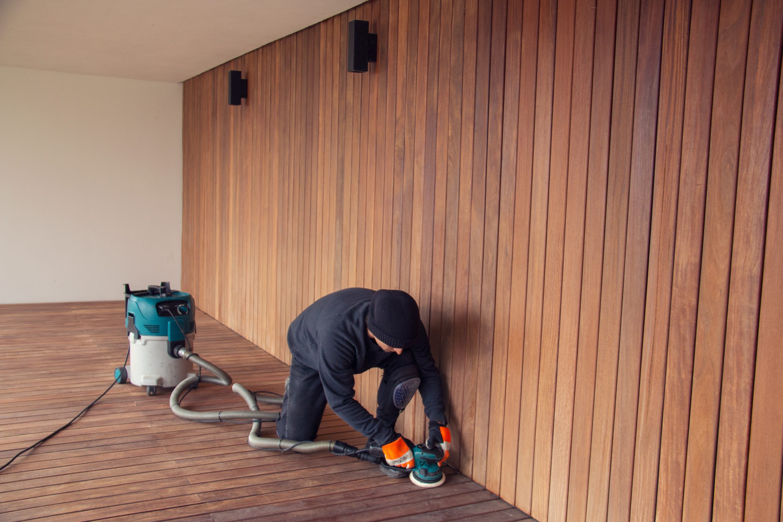 Deck Sanding in Rainham – professional sanding of a hardwood timber deck floor beside matching vertical cladding for a smooth, even finish.
