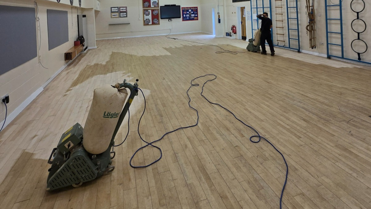 Commercial Floor Sanding Rainham – Maple Strip Hardwood School Hall Floor Sanding Commercial Floor Sanding in Rainham – maple strip hardwood school hall floor sanding in progress with professional sanding machines for a tough, long-lasting finish.