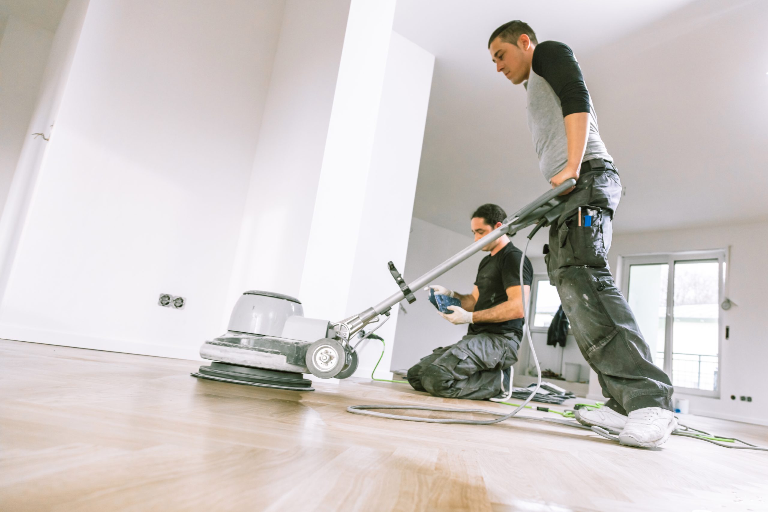 Commercial Floor Sanding in Rainham – oak parquet wood floor refinishing in progress with professional sanding machine, preparing a durable commercial finish.