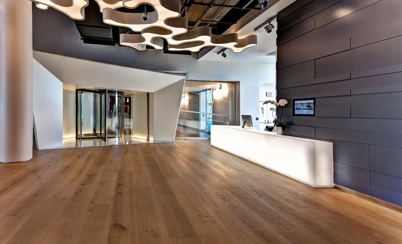 Commercial Floor Sanding in Rainham – wide oak plank hardwood reception floor restored smooth with a durable, professional finish for high-traffic commercial spaces.
