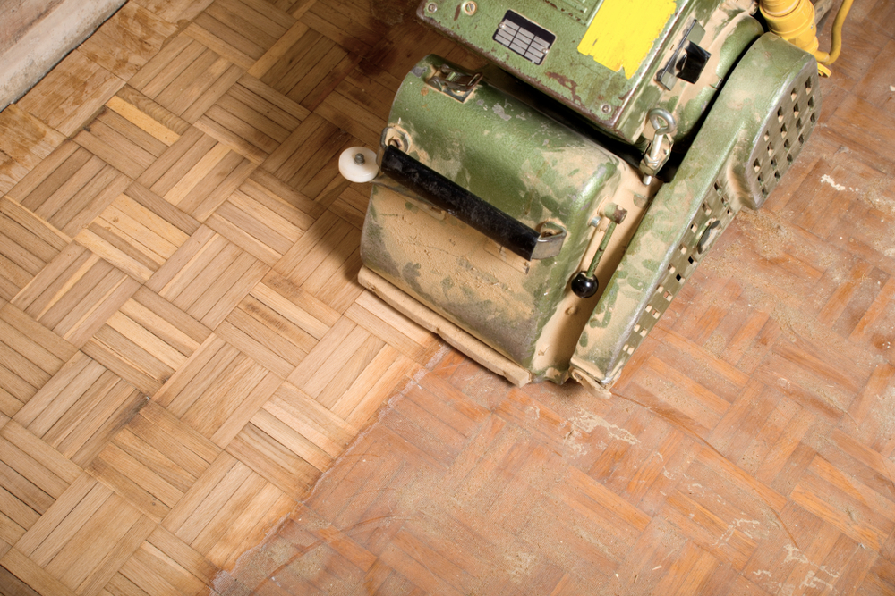 Commercial parquet floor sanding in Rainham RM13 using professional sanding equipment to remove old finishes and restore wooden flooring.